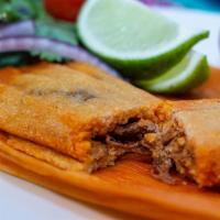 Pork Tamales - 4 pcs. · Pork shoulder simmered in a homemade guajillo sauce (NOT SPICY) and masa harina. Covered wit...