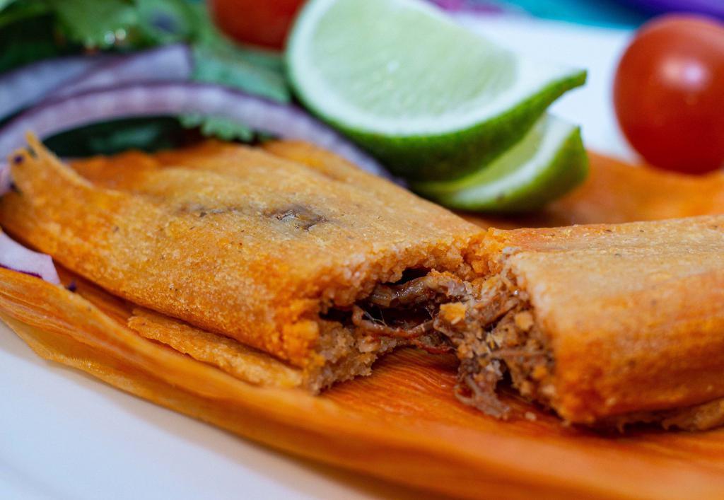 Pork Tamales - 4 pcs. · Pork shoulder simmered in a homemade guajillo sauce (NOT SPICY) and masa harina. Covered with a dry corn husk.