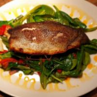 Rainbow Trout · Pan seared rainbow trout with spinach, cherry tomato, onion, garlic and butter.