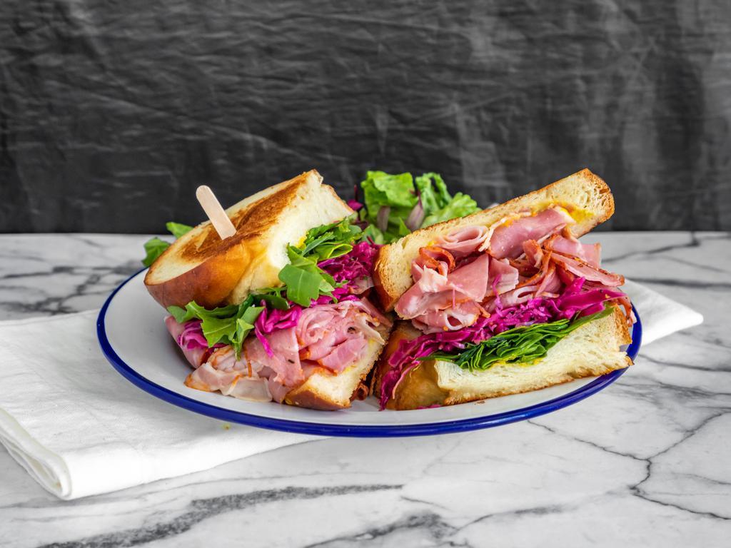 Pastrami sandwich · Toasted challah bread with pastrami, lettuce, pickled red cabbage, red onion, and mustard. 
The sandwich comes with a side of salad, and is also available on gluten-free challah bread on request. 