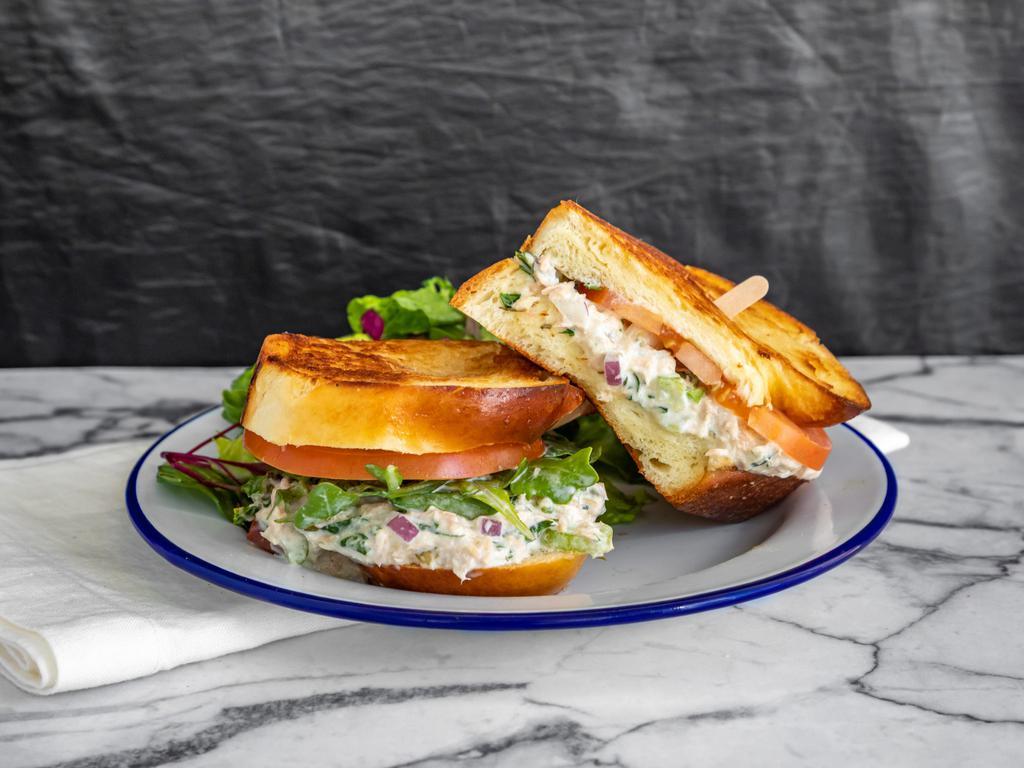 Tuna Salad Sandwich · Toasted challah bread topped with yellowfin tuna salad (which contains celery, red onion, capers, lemon juice, parsley, and aioli).
The sandwich comes with a side of salad, and is also available on gluten-free challah bread on request. 