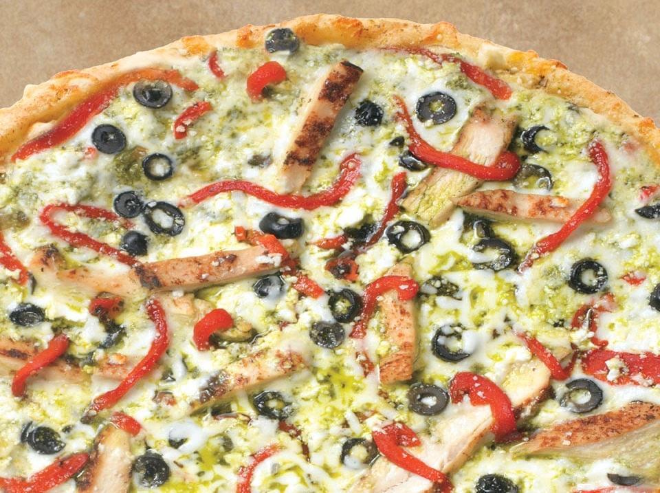 Chicken Pesto Artisan Pizza · A pesto sauce base layered with grilled chicken, roasted red peppers and black olives topped with feta, mozzarella and Pecorino Romano cheese. 