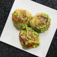 Garlic Knots (3) · House made garlic knots tossed in butter, parsley, garlic, and parmesan. Served with a side ...