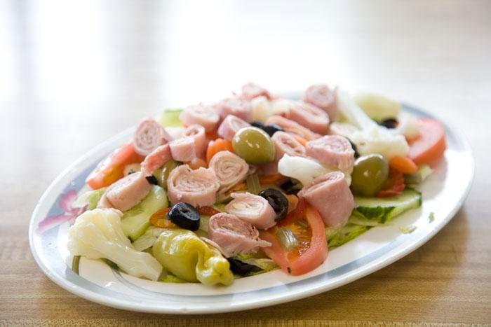 Antipasto Salad · Ham, salami, provolone, giardanera, lettuce, tomatoes, black and green olives. 