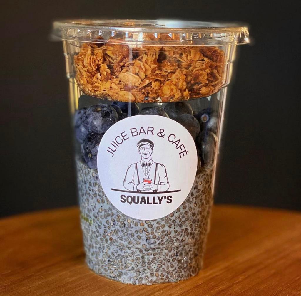 Chia Parfait · Chia pudding - chia seed and coconut milk, topped with coconut cream, seasonal berries, vegan and gluten-free granola, shaved coconut, and cacao nibs.