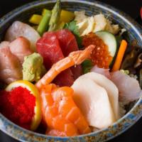 Chirashi · Assorted slices of raw fishes, shrimp, crab stick, tamago and pickles on sushi rice.