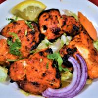 CHICKEN TIKKA (Appetizer) · Marinated in ginger, garlic, yogurt and spices cooked in clay oven.