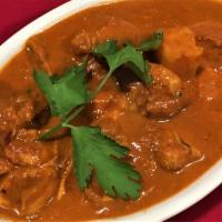 CHICKEN VINDALOO (Spicy) · Vinegar, red chilies and spices make a very hot curry. Served with rice.