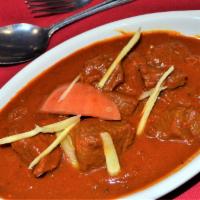LAMB ROGAN JOSH · Succulent pieces of lamb in cardomum aniseed and paprika flavored sauce. Served with rice.