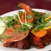 TANDOORI MIX GRILL · Assortment of lamb, chicken, and seafood cooked in clay oven. Served with rice.