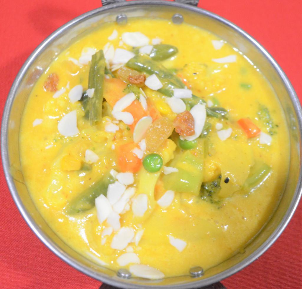 VEGETABLE KORMA · Assorted vegetables cookeRMAd in cream sauce, nuts and fruits. Served with rice.