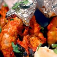 Tandoori Shrimp · Shrimps marinated with herbs and mild spices, fire grilled.