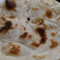 Tandoori Roti · Round shaped whole wheat bread baked in a traditional clay oven 