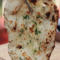 Nan · Traditional white bread, baked in the tandoor, with or without butter.