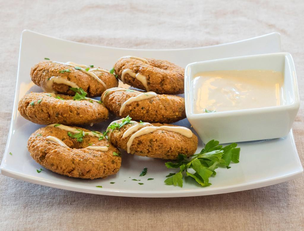 Falafel · Ground garbanzo and fava beans, seasoned and fried and served with tahini sauce. Vegan.