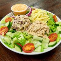 The Trio Salad · Chicken salad, tuna salad, egg salad, on a bed of lettuce, cucumbers and tomatoes.