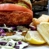 Awesome Fish Sandwich · Cod fish with homemade coleslaw, tartar sauce and tomatoes on a toasted roll.