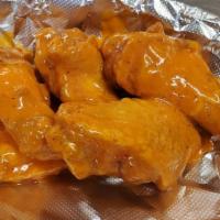 Regular Wings · Cooked wings of a chicken coated in sauce or seasoning. 