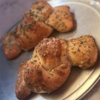 Garlic Knots with Cheese · A cross between garlic bread and pizza, cheesy bread is a quick, easy and delicious party sn...