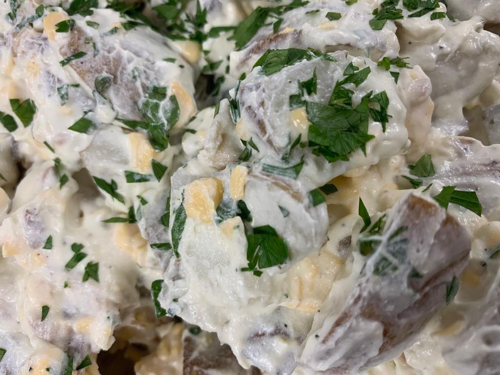 Baked Potato Salad · 1/2 pint baked potato salad made with baked potatoes, sour cream, mayonnaise, green onion, cheddar and bacon. 