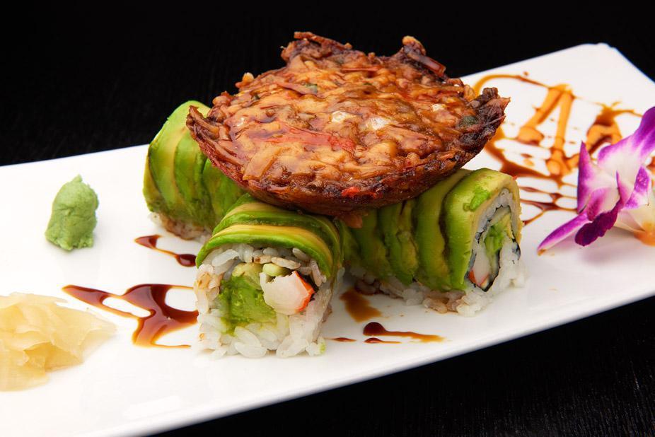 Volcano Roll · Kani, cucumber and avocado wrapped with avocado, and cooked spicy salmon.