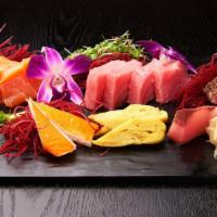 Sashimi Deluxe Combo · Four pieces of salmon, four pieces of tuna, two pieces of black pepper tuna, two pieces of y...