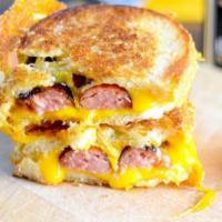 Grilled Cheese and Sausage · Cooked on a rack over a grill. Seasoned ground meat that has been wrapped in a casing.