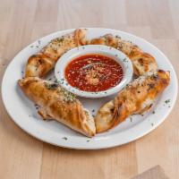 4 Pizza Rolls · Pizza dough formed into a pocket and filled with sauce and cheese. 