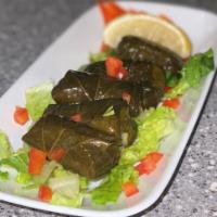 Dolmades · tender vine leaves wrapped into little rolls, stuffed
with rice and fresh herbs