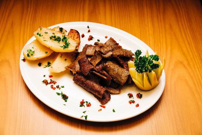 Lamb Gyro Platter · marinated hand-stacked meat, slow roasted and sliced off a vertical rotisserie