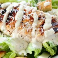 Chicken Caesar Salad · Juicy grilled chicken, on a bed of crispy romaine lettuce and croutons, topped with creamy c...