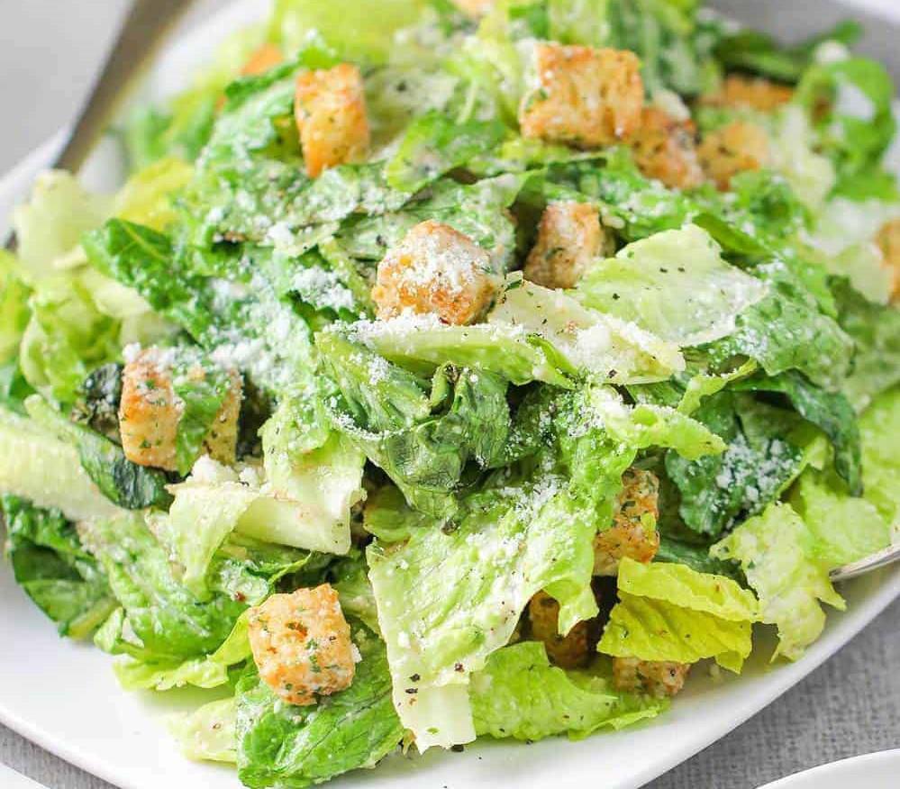 Caesar Salad · Crispy romaine lettuce & croutons tossed in creamy Caesar dressing; Topped with grated cheese. 