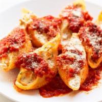 Stuffed Shells · Home made shells stuffed with ricotta cheese, tomato sauce and Parmesan cheese.