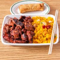 Boneless Spare Ribs Dinner Combo · A cut of meat with barbecue sauce 