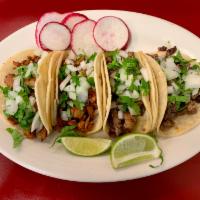 Tacos · Your choice of meat, onion, cilantro and red sauce 