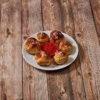 Garlic Knots · 6 pieces. Rolled baked garlic bread. Served with tomato sauce.