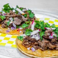 Steak Tacos (three) · 2 corn tortillas with melted cheese in between, steak, onion, cilantro, radish, and Aleppo c...