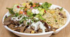 Gyro Plate · Sliced gyro meat on a bed of fries with tahini and cucumber yogurt. Served with couscous and...