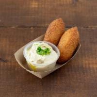 Kibbeh with Dipping Tahini Sauce · 2 fried bulgur croquettes stuffed with finely ground lean beef and minced onions.
