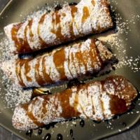 Caramel Apple Dessert Eggroll · Caramel-Cinnamon Apples wrapped delicately and deep-fried in an eggroll shell- dusted with p...