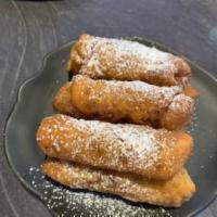 Chocolate Oooey-Gooey Dessert Eggroll · a blend of Chocolate, Caramel, Nuts, cheesecake filling and cookie crumbs, deep-fried in an ...