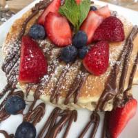 BERRY NUTELLA PANCAKES. · 3 buttermilk pancakes topped with fresh blueberries,strawberries and Nutella.