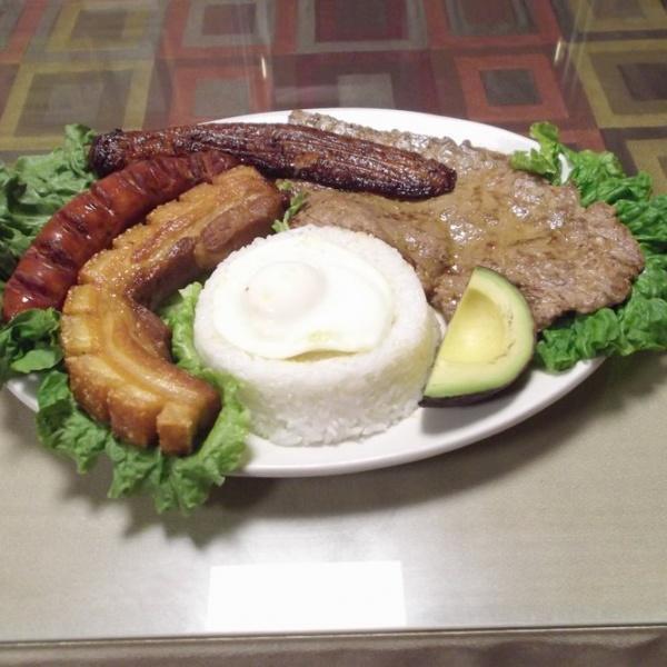 59. Bandeja paisa · Colombian typical platter: Rice, beans, sweet plantain, pork skin, sausage, grilled steak, egg and corn cake.