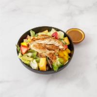 Ensalada Tropical · Chicken breast marinated over salad with mixed fruits and lettuce.