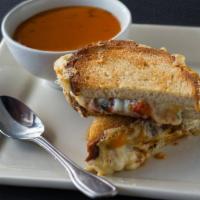 Grilled Cheese & Tomato Bisque · yellow and white cheddar, swiss, fontina, roasted tomatoes, artisan bread. 