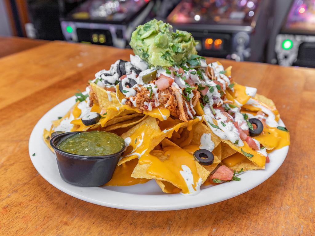 Nacho Kamacho · Fresh tortilla chips piled high with seasoned ground beef or shredded chicken, nacho cheese, pico de gallo, olives, jalapenos, blended cheese, green onions, guacamole and drizzled in cilantro lime sour cream and salsa.