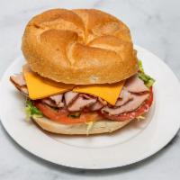 Turkey Club Sandwich Deluxe · Any choice of turkey with cheese, lettuce, tomato, and pickles.