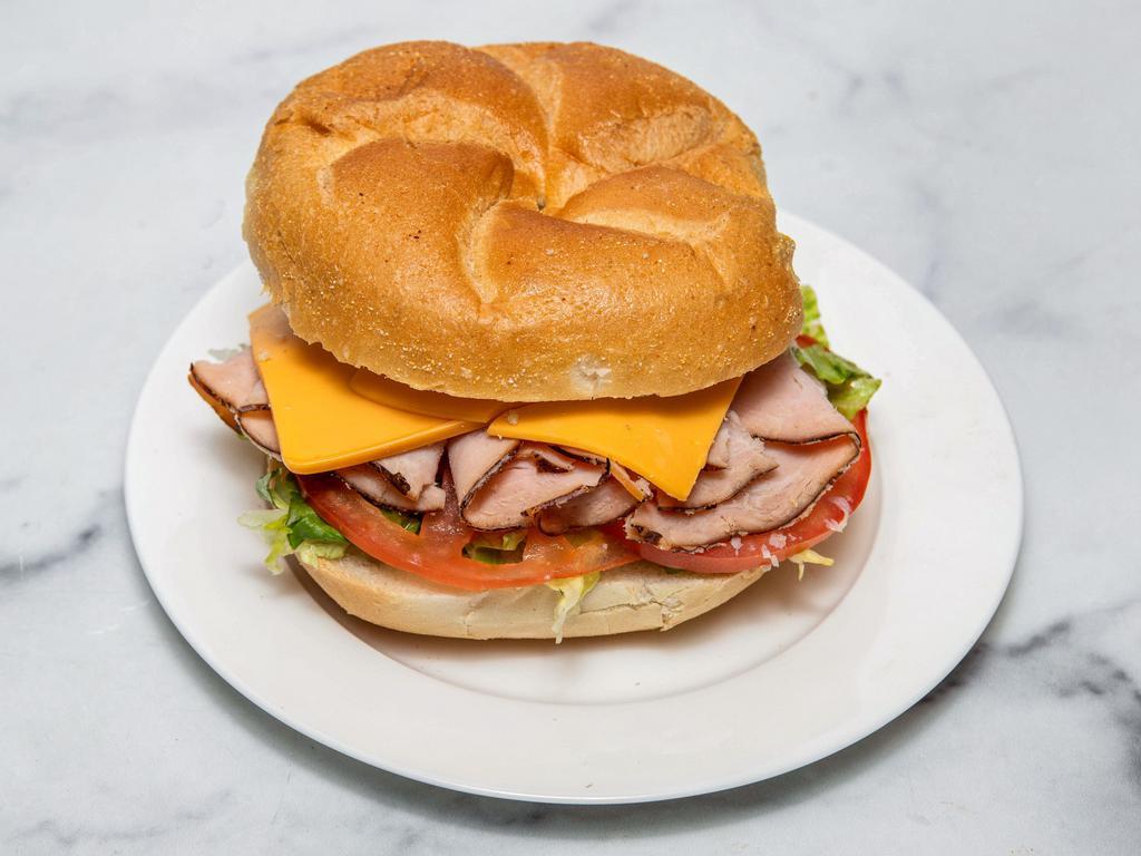 Turkey Club Sandwich Deluxe · Any choice of turkey with cheese, lettuce, tomato, and pickles.