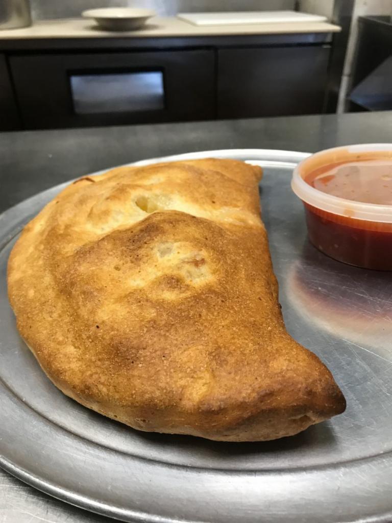 Calzone · With ricotta mozzarella and sauce on the side.