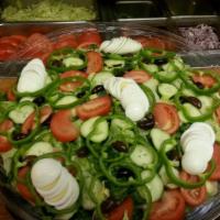 Tossed Salad · Served with fresh romaine and tender iceberg lettuce, tomatoes, cucumbers, onions, green pep...